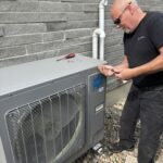 HVAC technician servicing heat pump and checking refrigerant levels during maintenance in Sarnia Ontario